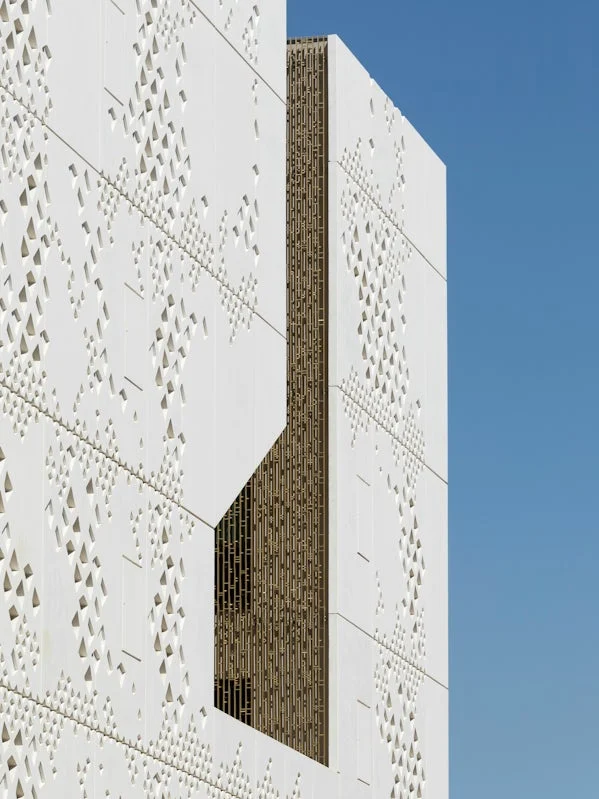 detail van prefab gevelpanelen met tactiele patronen geinspireerd op brailleschrift en mozaiekkunst