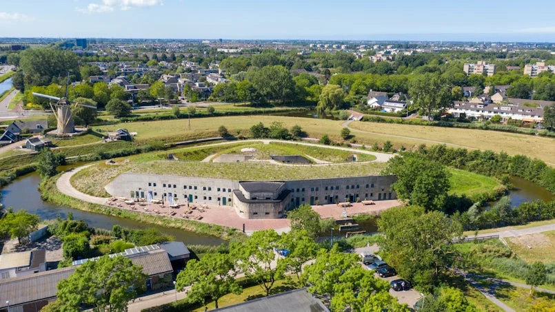 luchtfoto van het gerestaureerde fort – ligging in het landschap en zicht op de nieuwe invulling