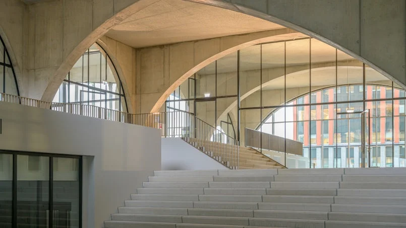 open atrium met trappartij en beplanting – zachte interieurinrichting contrasteert met ruw beton