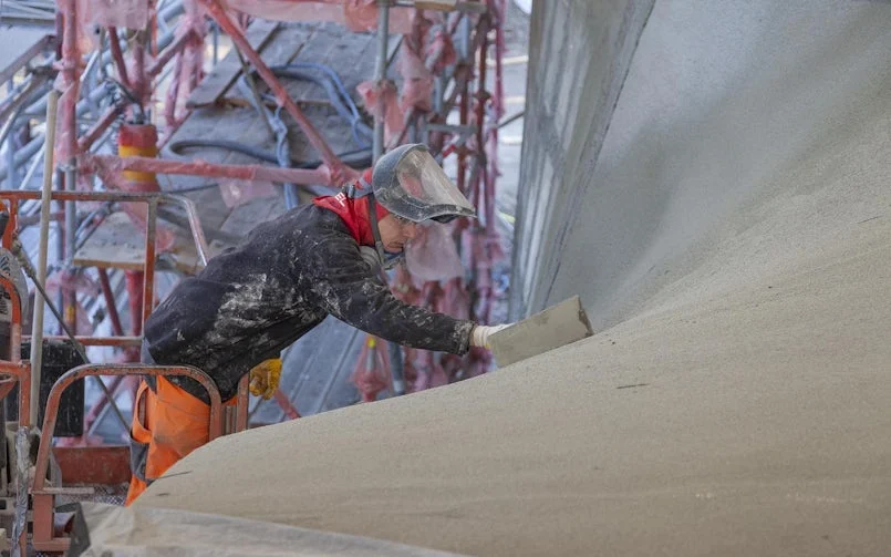 Ook het spuiten van het beton en het afwerken daarna gebeurt vanuit een hoogwerker (foto: Stefan Gröschel)